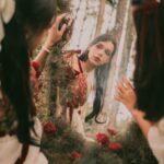 young women looking in the mirror in a forest